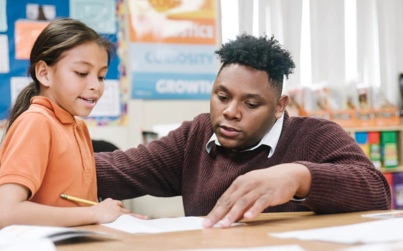 KIPP Northern California teacher guiding a student in learning.